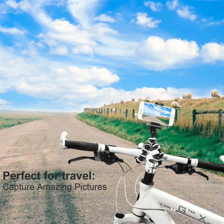 Flexible Grip Camera Tripod - Ideal for Mini Digital Cameras - Black 9 Bike With Smartphone Mounted On A Camera Tripod On A Scenic Countryside Road, Capturing Travel Photos, Outdoor Adventure, Cycling Scenery, And Nature Photography, Ideal For Travel And Adventure Enthusiasts, Syndmart Product Display, Lifestyle Image, Scenic View, Colorful Sky, And Lush Landscape, High Quality, Vibrant, Outdoor, Travel, Cycling, Photography, Adventure, Scenic, Nature, Road Trip, Technology.