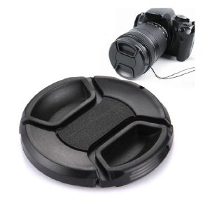 Camera lens cap holder with camera on white background, portable camera accessories for lens protection, durable and lightweight camera gear, ideal for photographers and photography enthusiasts, compatible with various camera models.