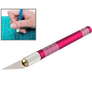 Blue cutting mat with precision craft knife for model making and detailed work, creative hobby tools, DIY projects, and artistic craftsmanship.