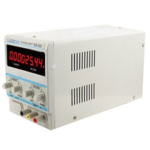 Digital laboratory power supply with digital display, adjustable voltage and current controls for precision testing.