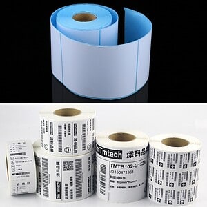 Heat transfer labeling rolls with blue backing and barcode labels for product packaging.