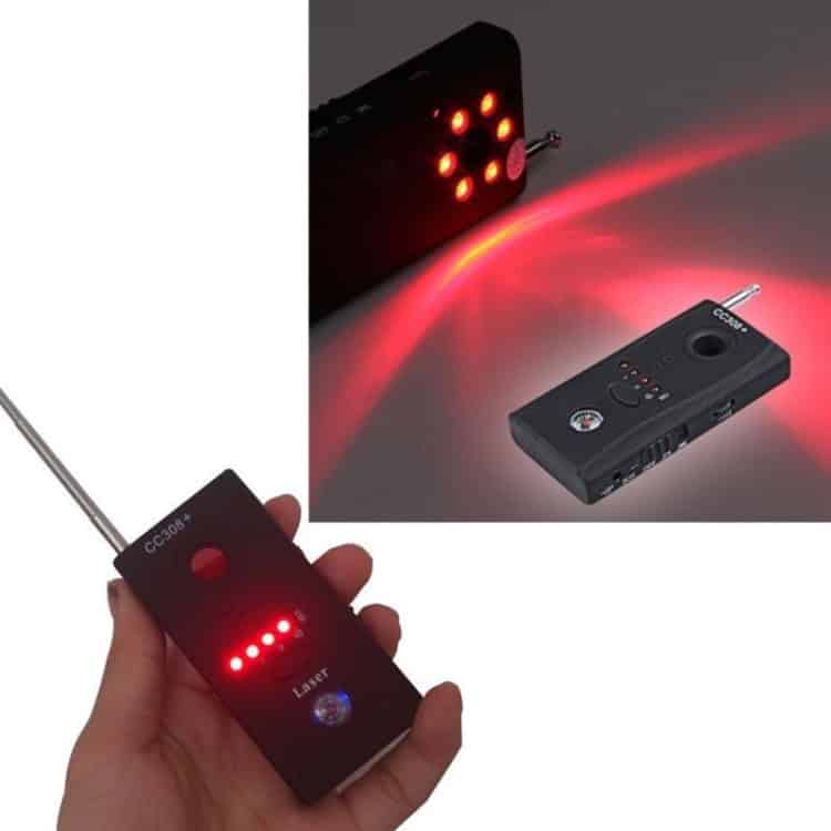 CC308+ Wireless Camera Lens Detector RF Signal GSM Finder (EU Plug) 9 Hand Holding A Black Laser Pointer Device With Led Indicators And A Red Laser Beam.