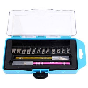 Precision tattoo needle cartridges and replacement tools in a compact travel case for tattoo artists.