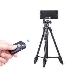 Wireless remote shutter release for smartphone camera on tripod, picture of hand holding remote, modern photography accessories, mobile video recording equipment, remote control for photography shooting, image relevance to syndmart technology products.