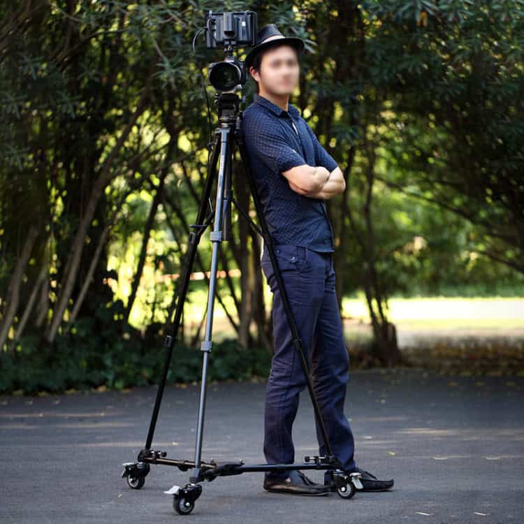 YUNTENG 901 Tripod Wheel Base - Supports 30KG - Enhanced Mobility & Stability 8 Professional Videographer Using A Camera On A Stabilizer For Outdoor Filming At Syndmart.