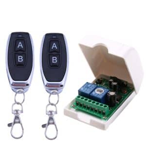 Remote control system featuring two key fobs and a control module in a protective casing.