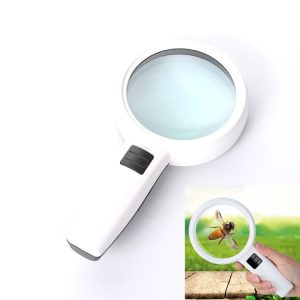 Handheld magnifying glass with a white handle and a clear lens focusing on a bee.