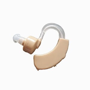 Soft beige hearing aid with clear tubing, designed for discreet amplification and improved hearing support.