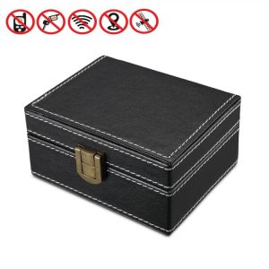 Black jewelry storage box with brass latch, leather-like texture, and white stitching for elegant organizing, ideal for watches, rings, and accessories.