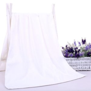 Soft white fabric backdrop or canopy with wooden stand, ideal for photography or events, featuring a basket of purple and lavender artificial flowers for decorative purposes.