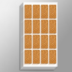 Golden brown rectangular cork coasters arranged in a white tray on a neutral background.