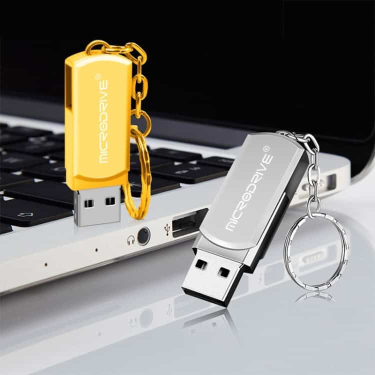 Creative 8GB MicroDrive USB 2.0 Metal U Disk with Keychain 6 Flash Drive Keychains With &Quot;Microdrive&Quot; Branding, One Yellow With Gold Chain, And One Silver With Silver Chain, Resting On A Laptop Keyboard, Emphasizing Portable Data Storage And Promotional Branding For Tech Accessories.