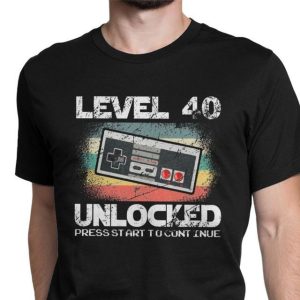 Black T-Shirt Featuring A Vintage Video Game Controller Graphic With The Text 'Level 40 Unlocked'.