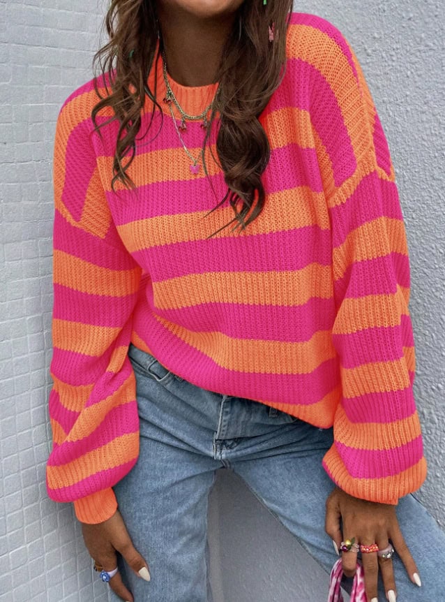 Chic Stripe Love Drop-Shoulder Sweater: Cozy Knit Fashion Statement 5 Colorful Pink And Orange Striped Knitted Sweater Worn By A Woman, Casual Fashion Style.