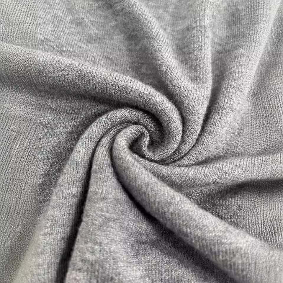 Solid Color French Short Sleeve Sweater - Simple Round Neck Charm 8 Close-Up View Of A Gray Fabric Showing A Smooth, Soft Texture With Folds And Twists.