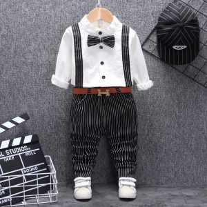 Elegant Children'S Formal Outfit Featuring A White Shirt With Suspenders, Black Pinstriped Pants, A Matching Bow Tie, And White Sneakers, Perfect For Special Occasions And Events.