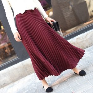 Elegant burgundy pleated maxi skirt for women, perfect for stylish casual or formal outfits, paired with a white top and accessories, ideal for fashion-conscious individuals.