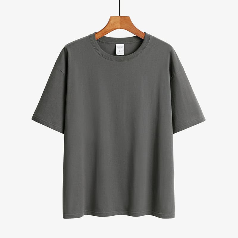Classic Round Neck Drop Shoulder T-Shirt - Comfort meets Style! 7 Gray Short Sleeve T-Shirt Displayed On A Wooden Hanger Against A Plain Background.