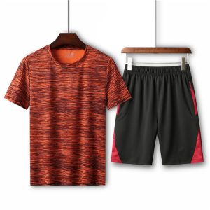 Vibrant orange and black athletic t-shirt with a dynamic stripe pattern paired with black and red sports shorts, ideal for workout and running activities.