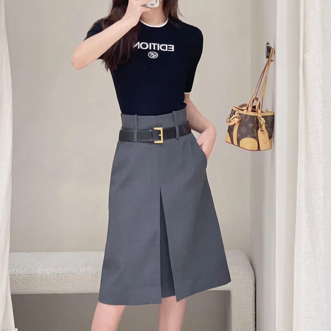 Classic Gray Worsted A-Line Skirt for Women - Perfect Business Wear 5 Stylish Professional Outfit Featuring A Black Graphic T-Shirt And Gray Midi Skirt With A Belt, Accessorized With A Designer Tote Bag, Perfect For Corporate Or Business Casual Occasions On Syndmart.