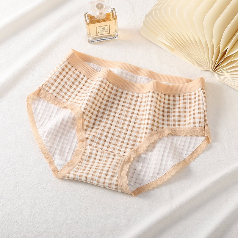 Cute Bear Student Underwear Set for Girls - Adorable Cartoon Design! 6 Beige Checkered Women'S Lace-Trimmed Panties Laid Out On A White Surface With A Perfume Bottle And An Open Book Nearby.
