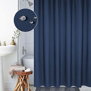 Water droplets on navy blue shower curtain displaying water-resistant fabric and textured pattern.