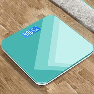 Digital bathroom scale with LED display on wooden floor.