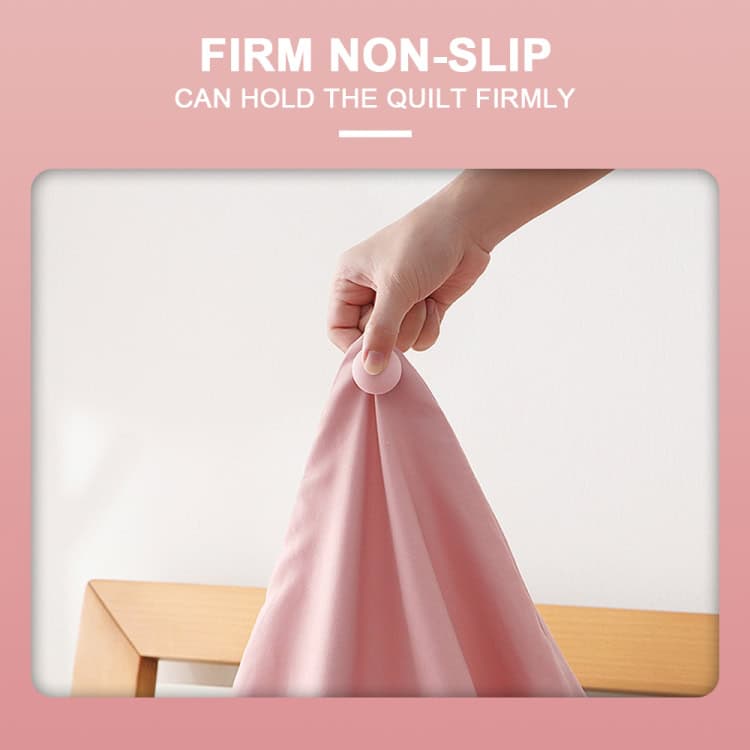 8-Piece Non-marking Mushroom Quilt Fixer Set with One-touch Unlocking 3 Hand Holding A Pink Quilt With A Non-Slip Grip Feature For Secure Placement.