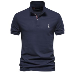 Elegant Navy Blue Polo Shirt With Embroidered Giraffe Logo, Short Sleeves, And Button Collar, Perfect For Casual Or Semi-Formal Occasions. Made From High-Quality, Comfortable Fabric For Everyday Wear.
