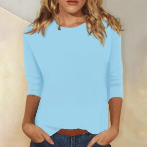 Light Blue Long Sleeve Top Worn By A Model With Hands In Pockets.