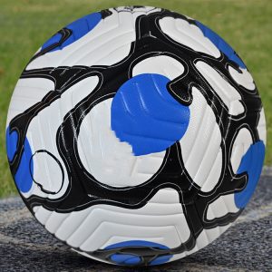 Vibrant soccer ball with blue, black, and white design for outdoor sports.