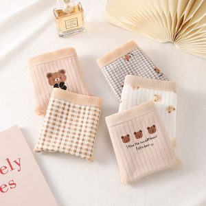 Soft teddy bear and checkered patterned socks with cute bear designs, ideal for cozy loungewear or gifting. Perfectly at home in stylish, comfortable, and trendy fashion collections.
