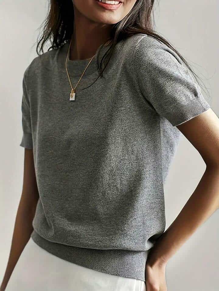 Solid Color French Short Sleeve Sweater - Simple Round Neck Charm 6 Woman Wearing A Gray Short-Sleeve Sweater With A Round Neckline And A Subtle Ribbed Hem.