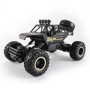 Remote control off-road vehicle with large tires and a black chassis designed for rugged terrain.