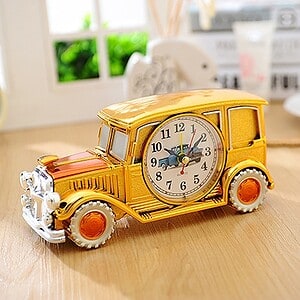 Vintage yellow school bus clock toy with a whimsical design and colorful details, perfect for desk decor and gift shops.