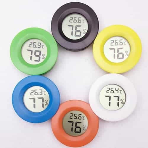 Digital Round Reptile Box Centigrade Thermometer & Hygrometer with Screen Display 7 Six Round Digital Thermometers In Various Colors Displaying Temperature And Humidity Readings.