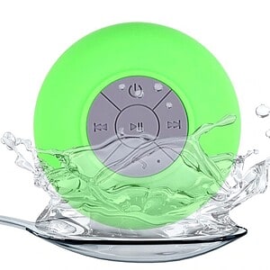 Green waterproof Bluetooth speaker with control buttons, partially submerged in water.
