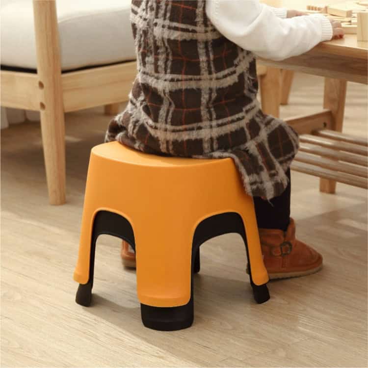 Thick Plastic Bathroom Stools - Low Square Benches for Household Use 4 1. Child Sitting On A Colorful, Ergonomic Kids' Stool In A Cozy Home Setting, Promoting Safe Seating And Comfort For Children.
