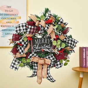 Black and white checkered Christmas wreath with red berries, burlap ribbons, and greenery, decorative holiday door hanger for Christmas season, festive home decor, Syndmart product.